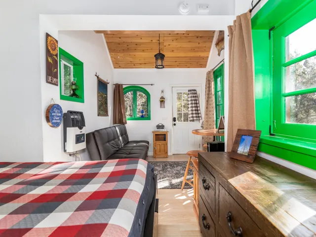 Interior space featuring a wood-finish ceiling, light wood-finish flooring, and white walls