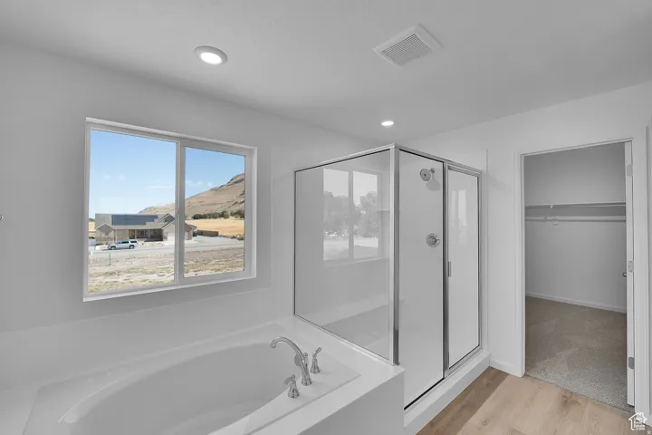 White soaking tub with deck-mounted chrome fixtures