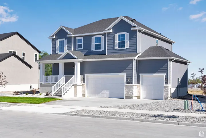 Contemporary two-story residence featuring a blue siding exterior with white window shutters