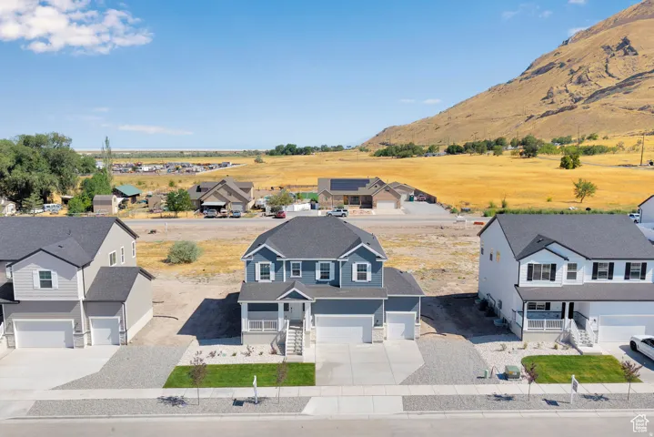 Two-story residence featuring a dark gray roof, blue siding, and white trim accents
