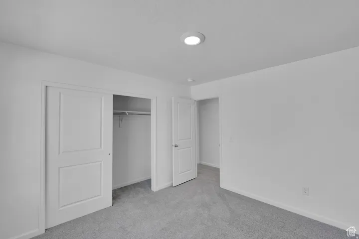 Room featuring light gray carpet flooring, white walls, and a recessed ceiling light