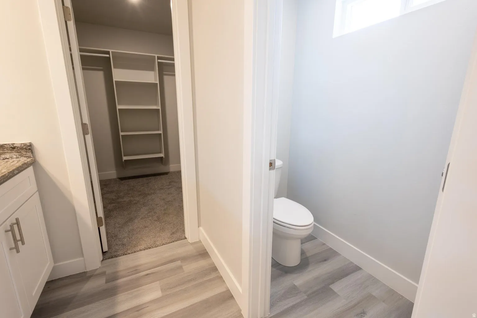 Modern vanity with a granite countertop and matte silver hardware