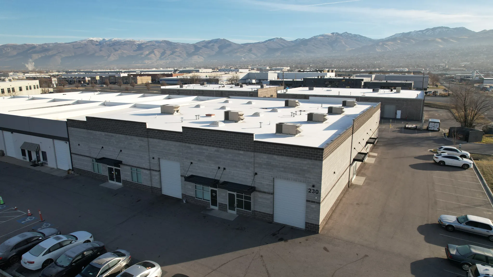 Commercial building with a light-colored flat roof and multiple rooftop units