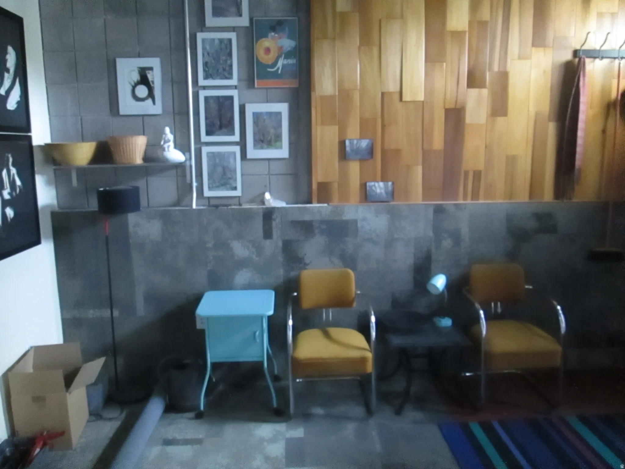 Concrete block wall with a floating shelf and varied wood paneling