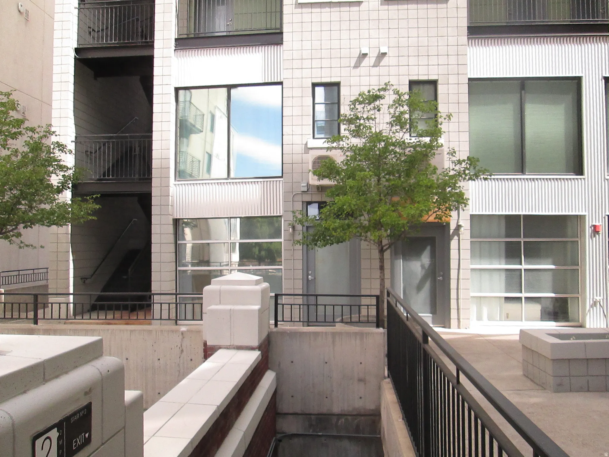Modern building facade featuring large windows and textured paneling