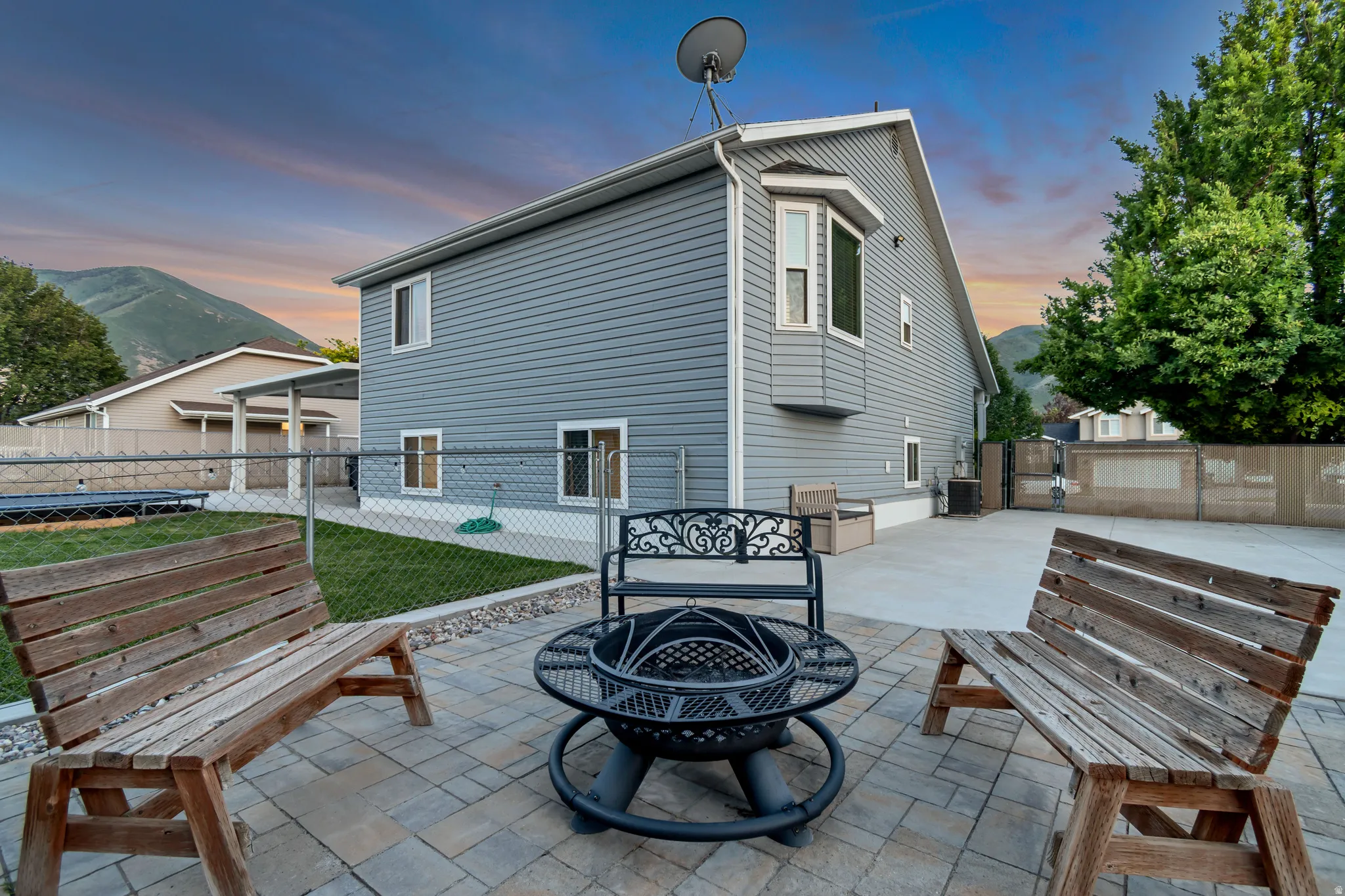 Expansive paver patio with a central fire pit