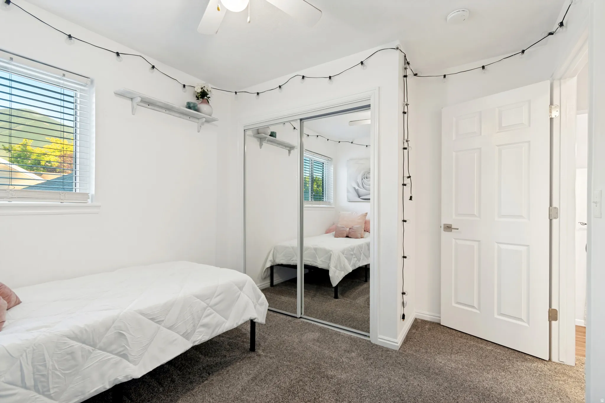 Bedroom featuring light-colored walls and grey carpet flooring