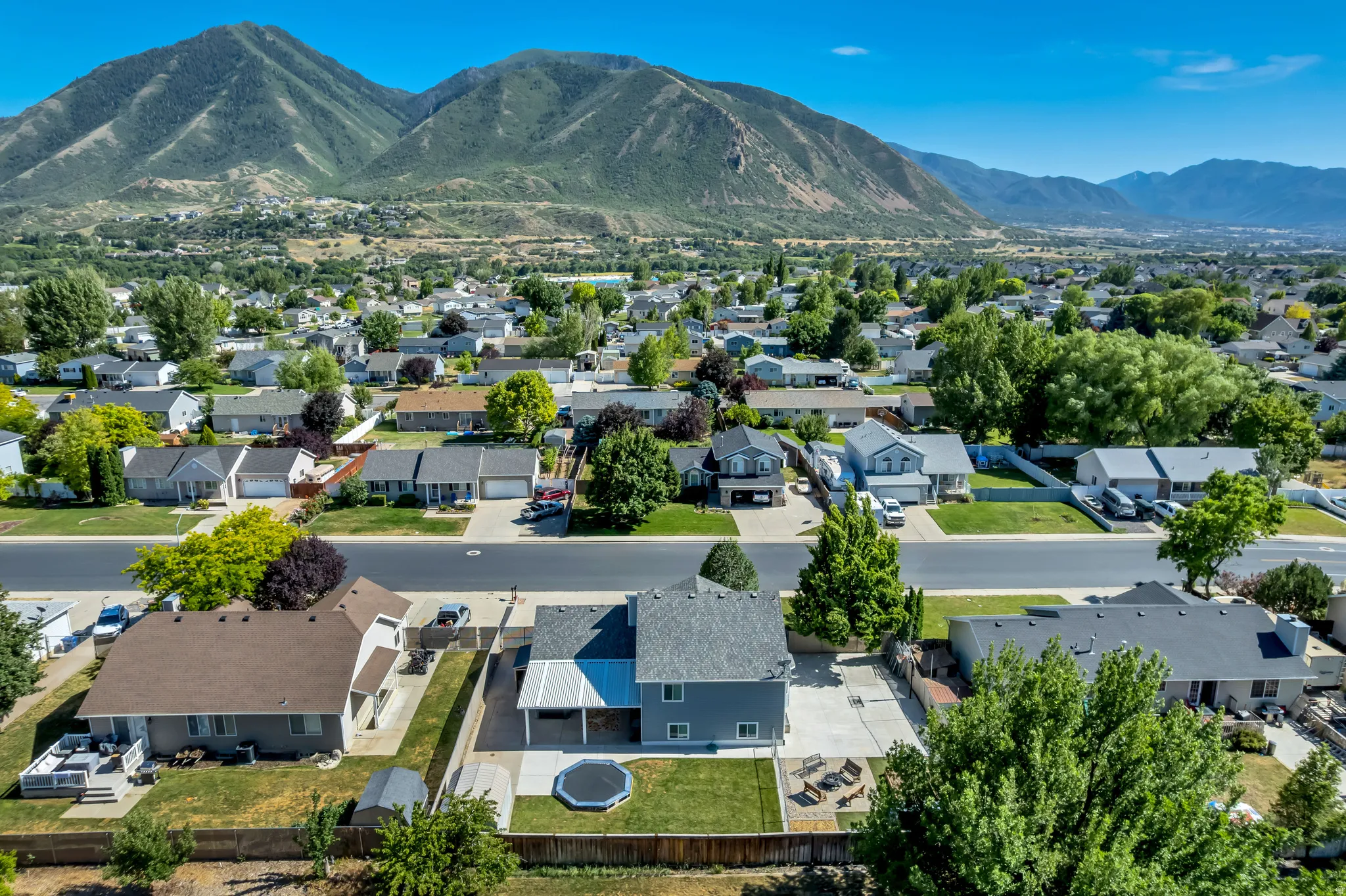 Aerial perspective showcasing a residential neighborhood with mountain backdrops