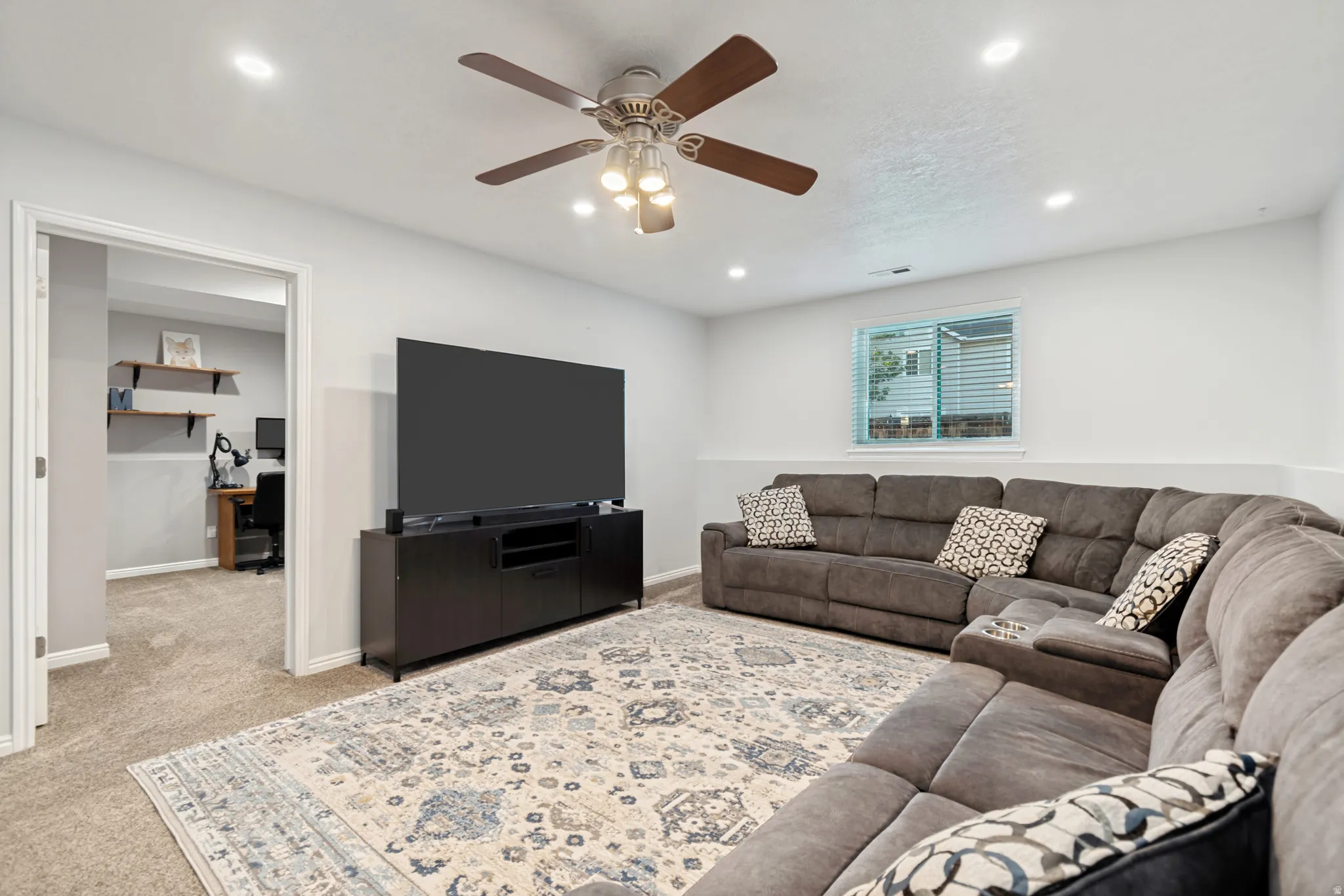 Spacious room with recessed lighting and a ceiling fan