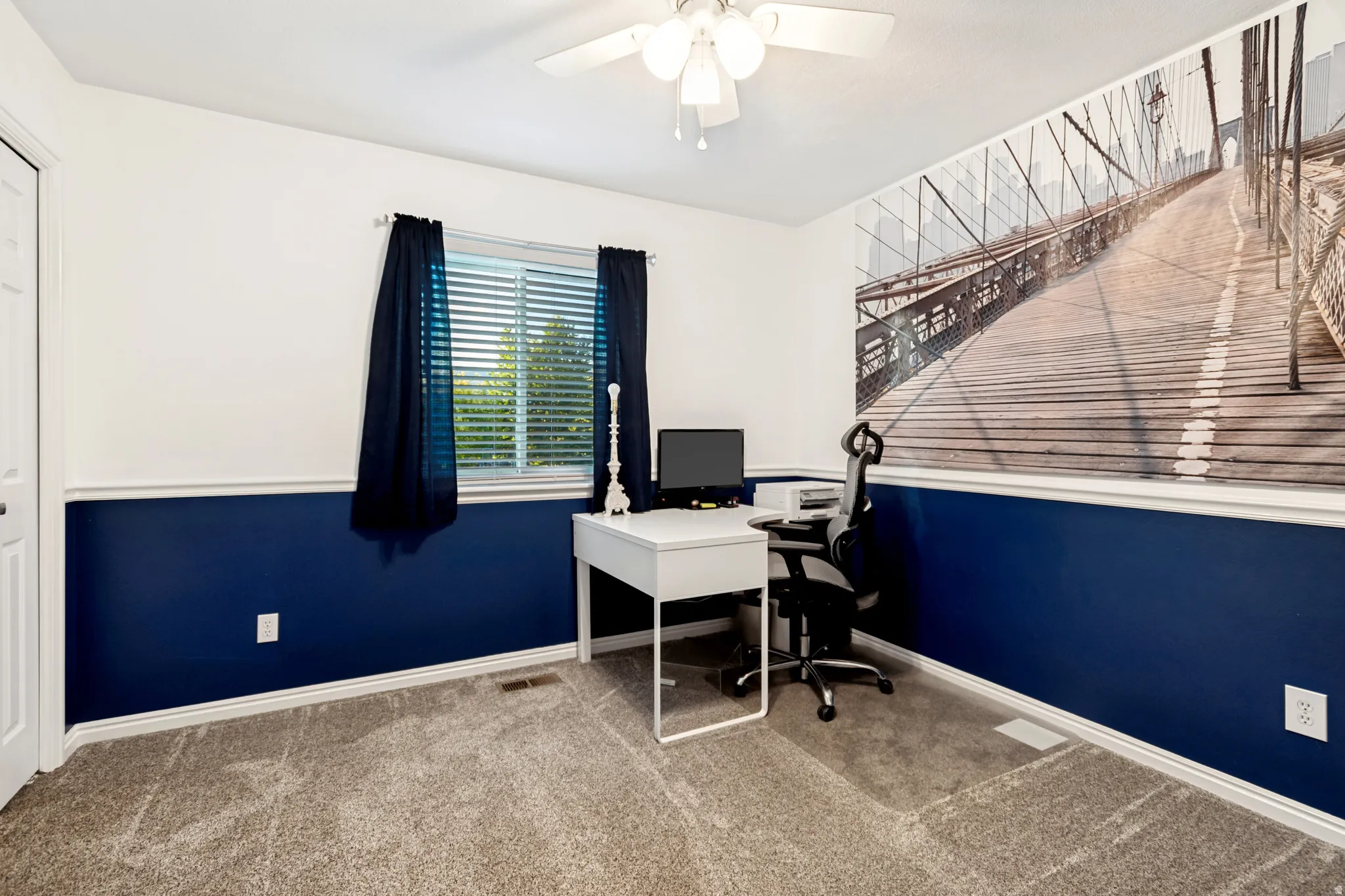 Room featuring two-tone walls with a white upper section and a blue lower section, complemented by white trim