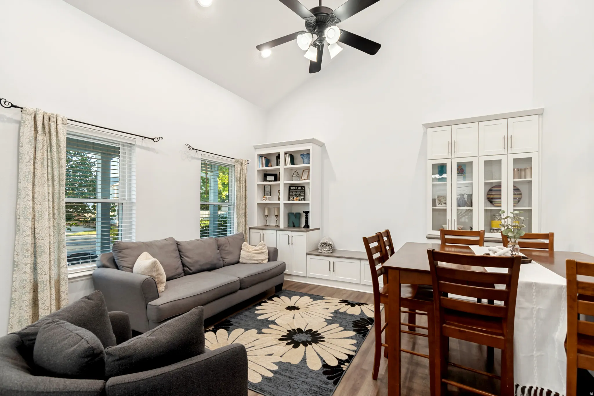 Spacious living area featuring vaulted ceilings, recessed lighting, and wood-finish flooring