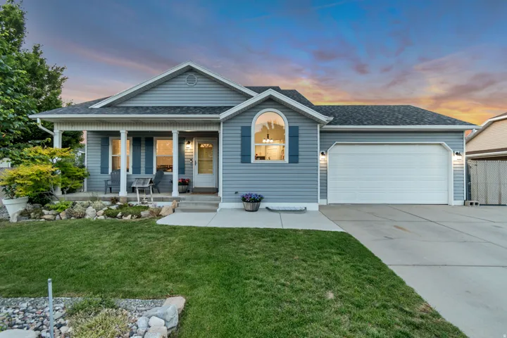 Light blue siding exterior with a covered porch featuring white columns
