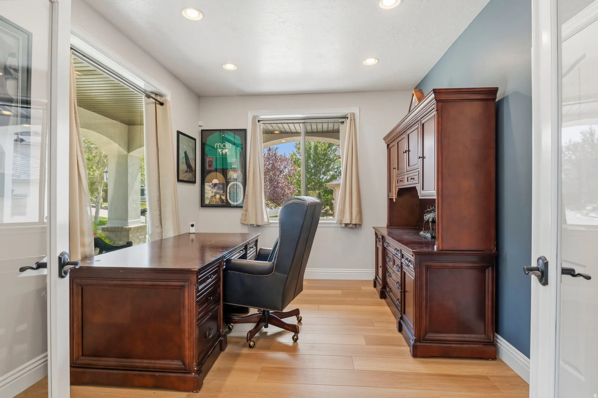 Bright interior space featuring light wood-finish flooring, recessed lighting, and a window with exterior views
