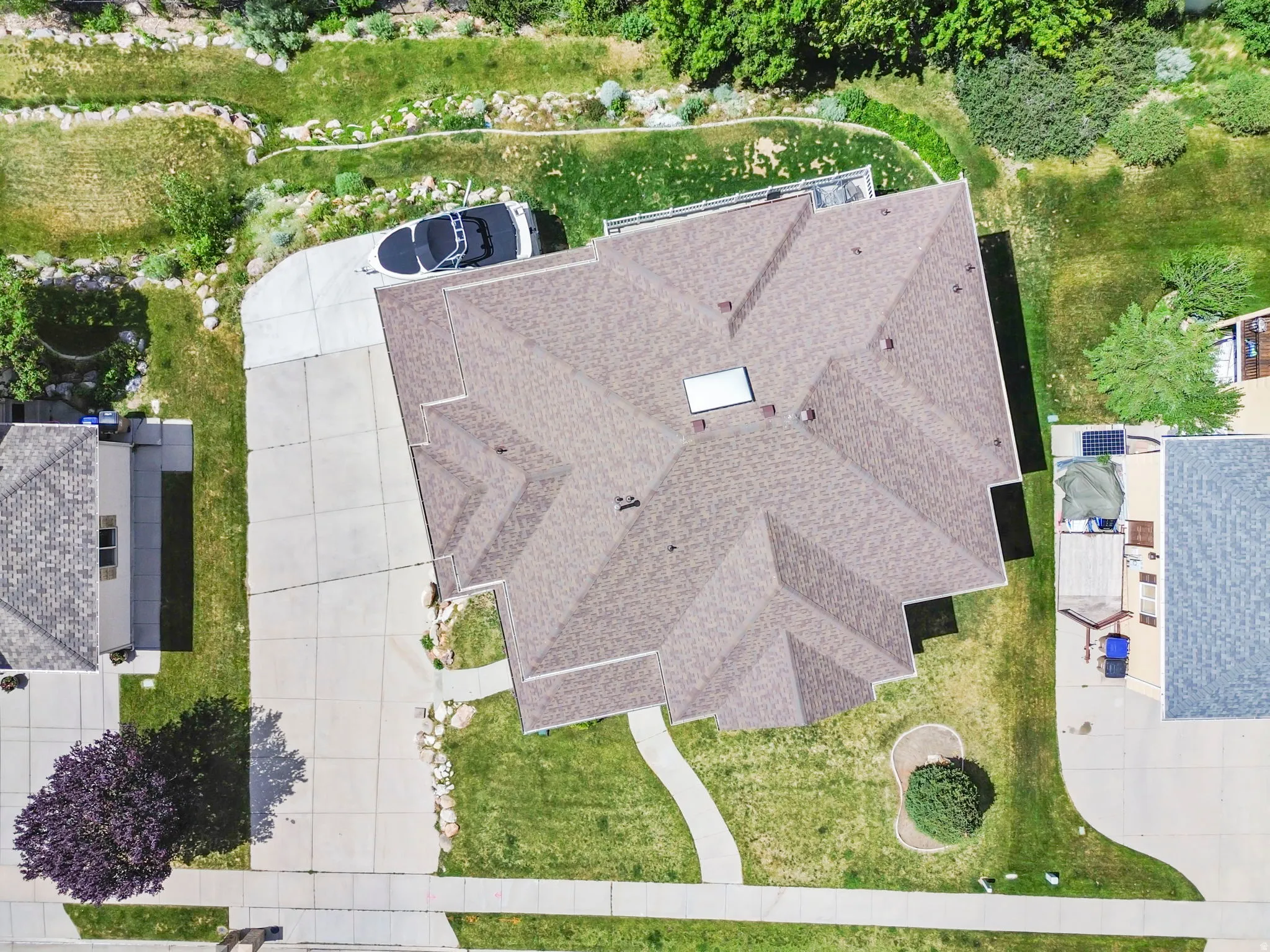 Pitched shingle roof with a skylight and multiple roof vents