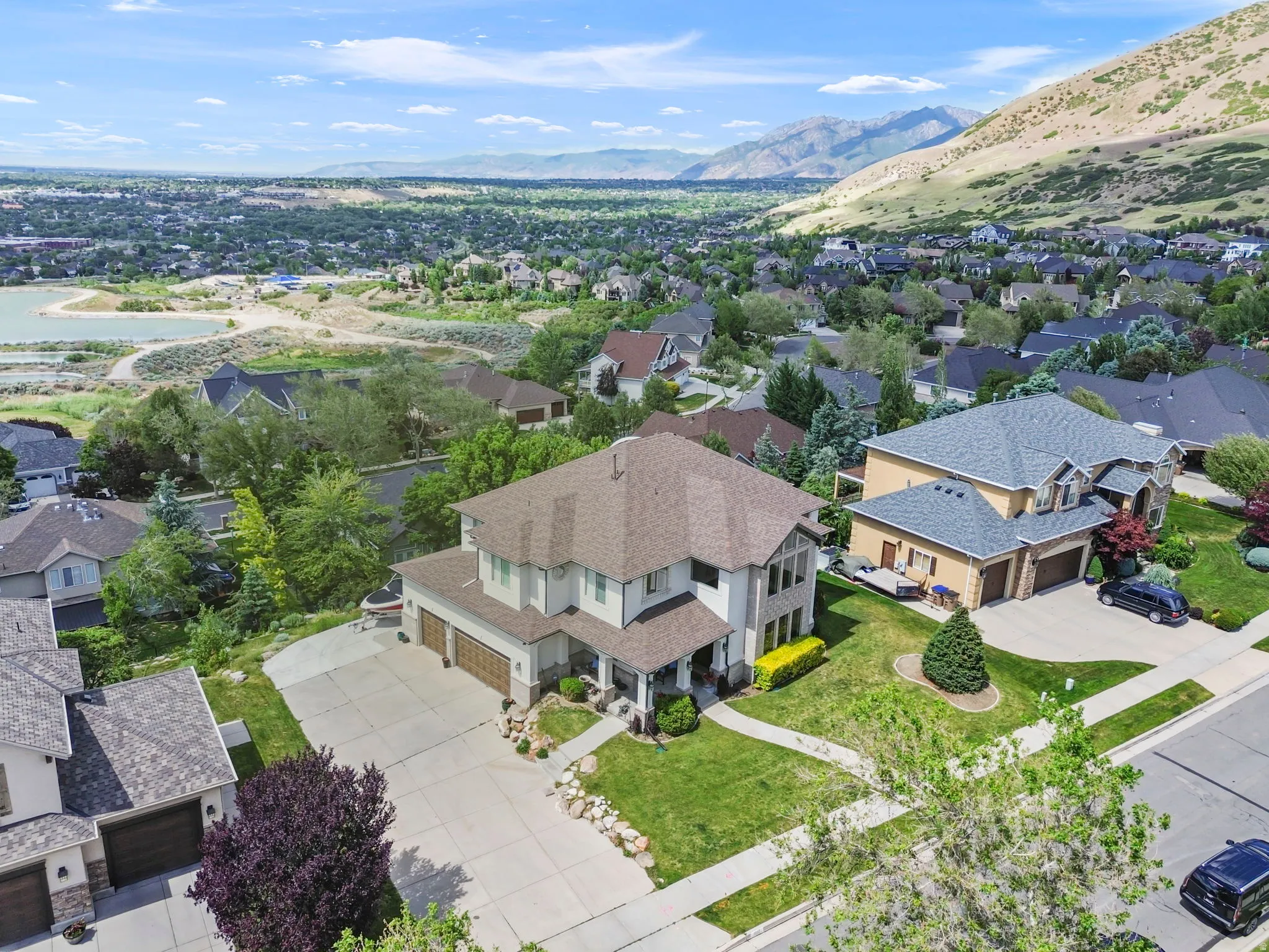 Two-story residence featuring a multi-gabled roofline and a stone and stucco exterior