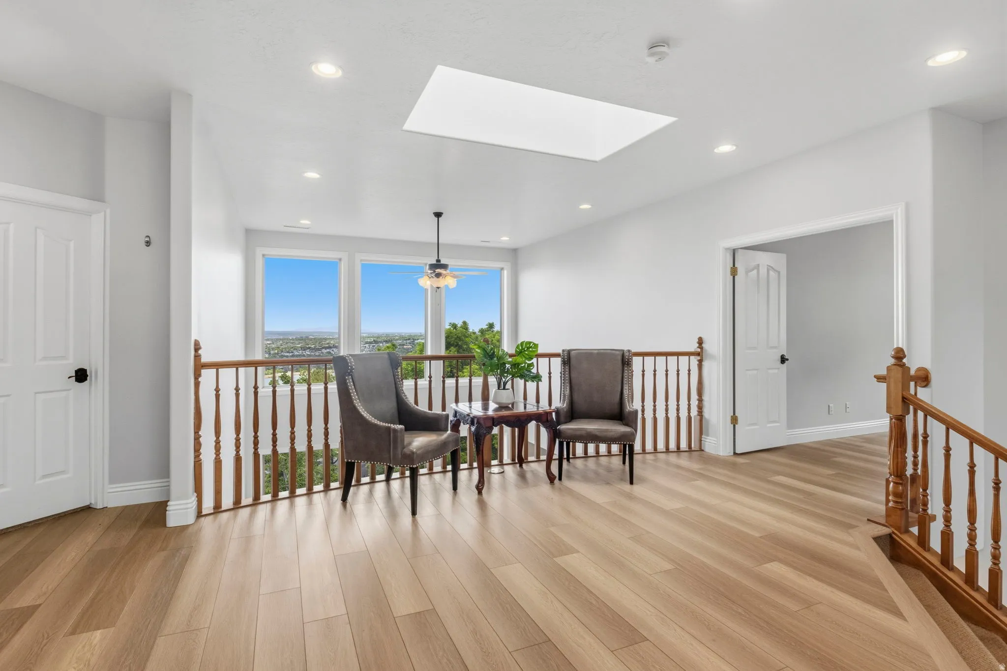 Upper level landing featuring wood-finish flooring
