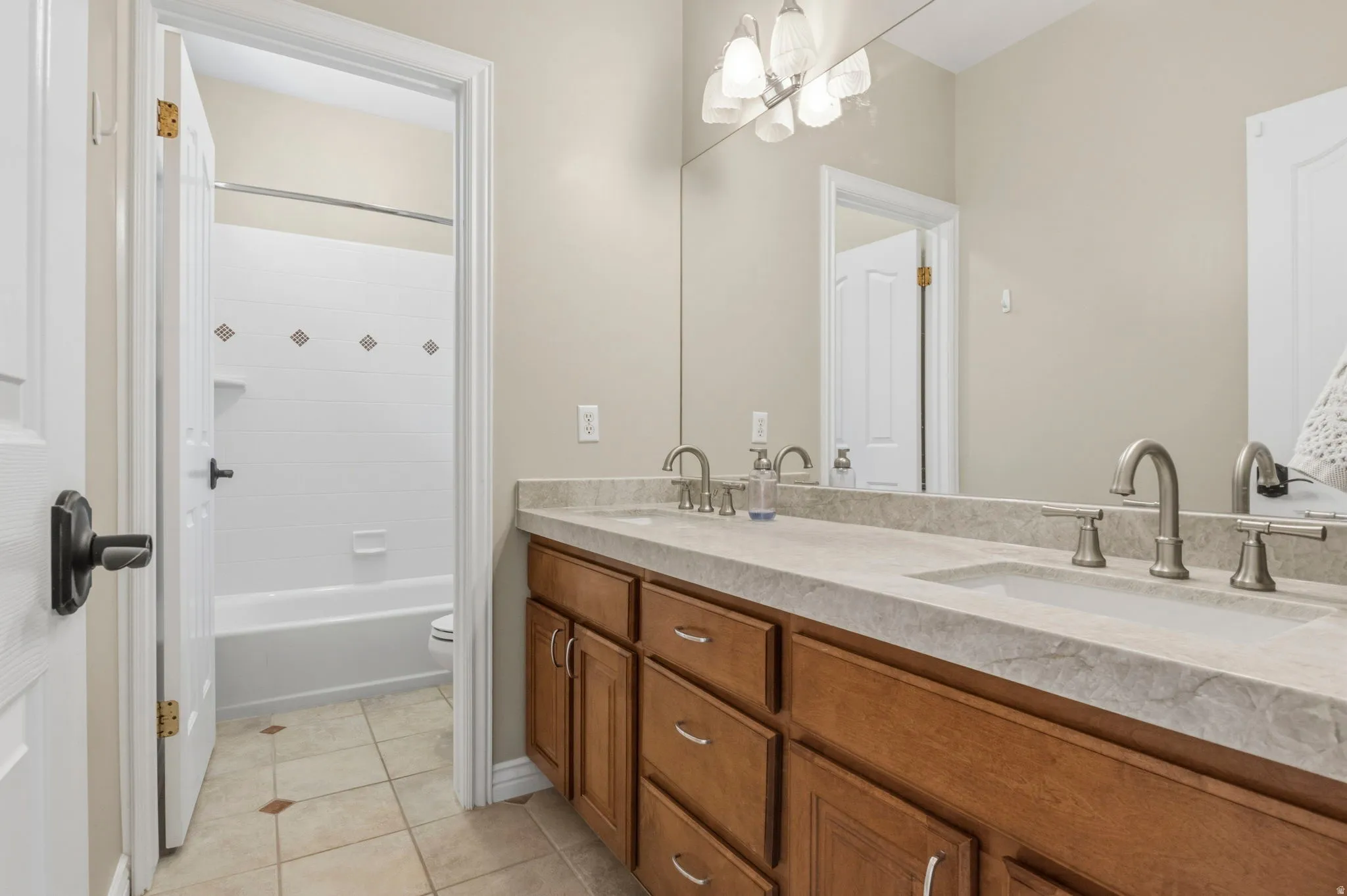 Bathroom vanity with dual undermount sinks and brushed nickel faucets