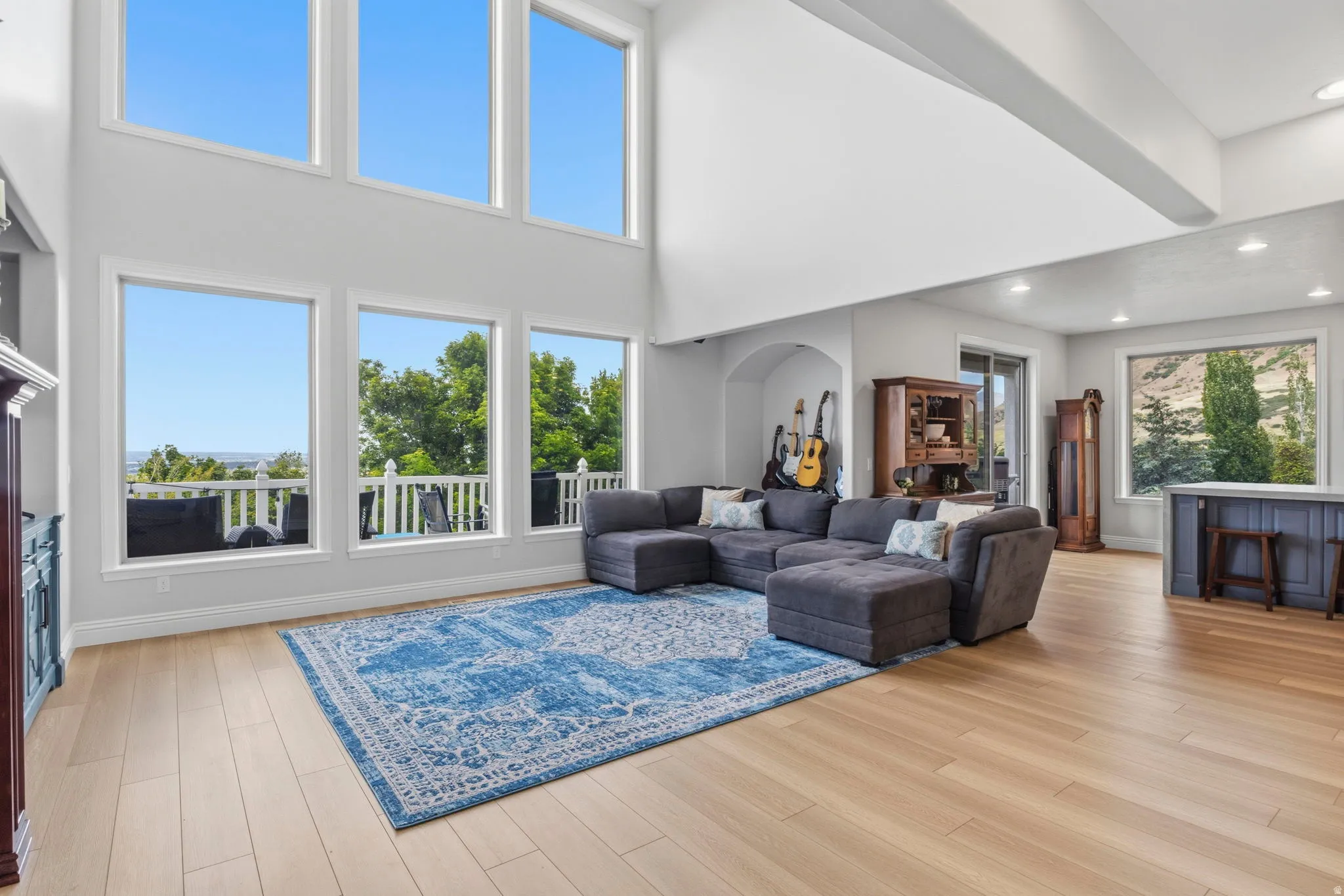 Two-story great room featuring high ceilings and a wall of windows