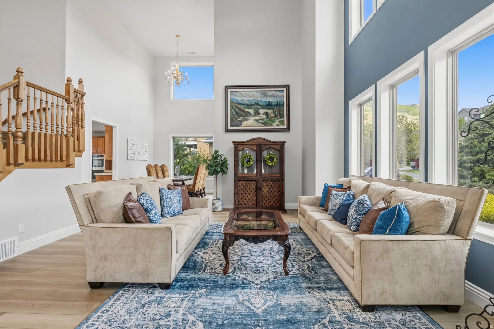Expansive living area featuring soaring ceilings and wood-finish flooring