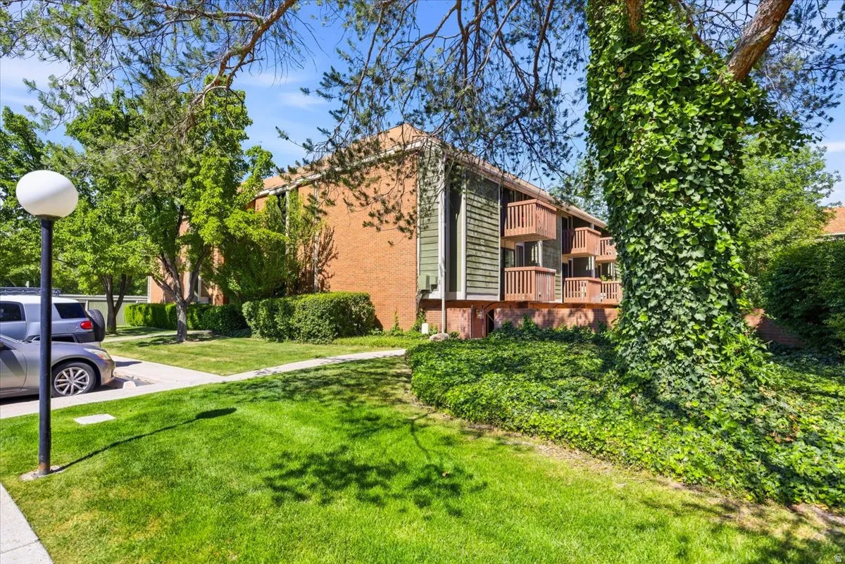 Multistory brick building featuring private balconies with wood railings