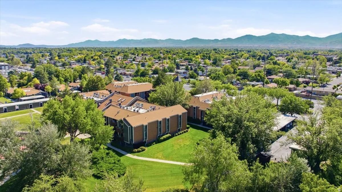 Multi-story residential buildings with brown roofs and green exterior siding