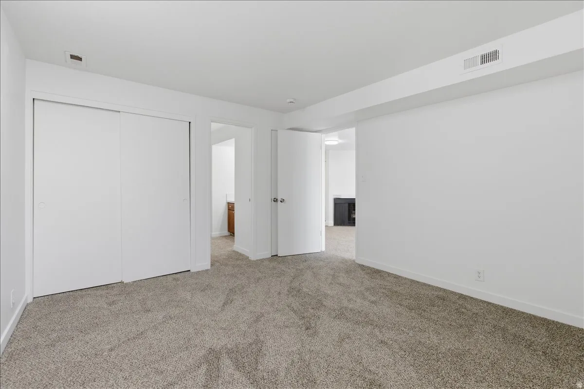 Neutral-toned carpet flooring and white walls