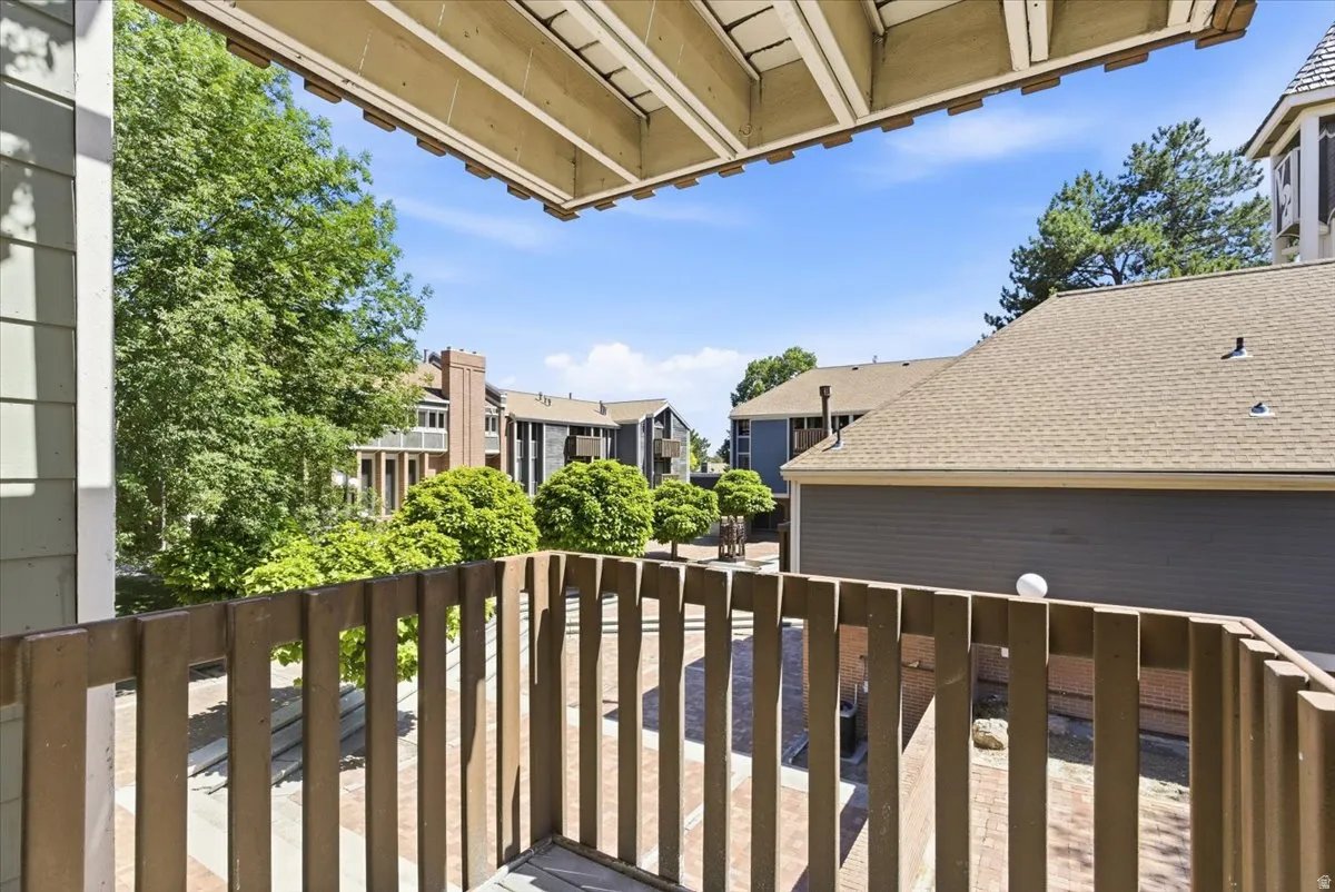Private balcony featuring wooden railing
