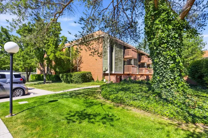 Multistory brick building featuring private balconies with wood railings