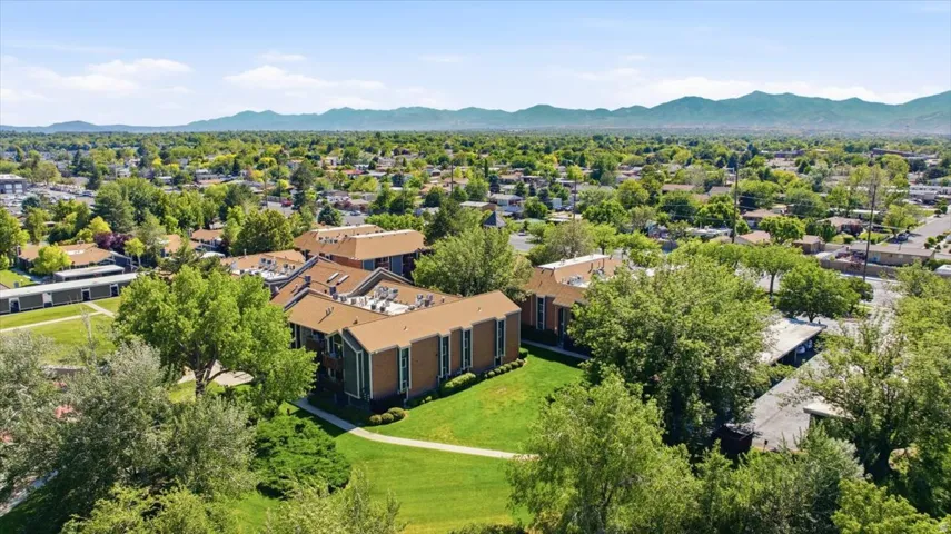 Multi-story residential buildings with brown roofs and green exterior siding