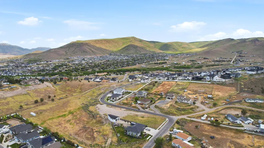 Residential property parcel outlined in white, situated on a curved roadway