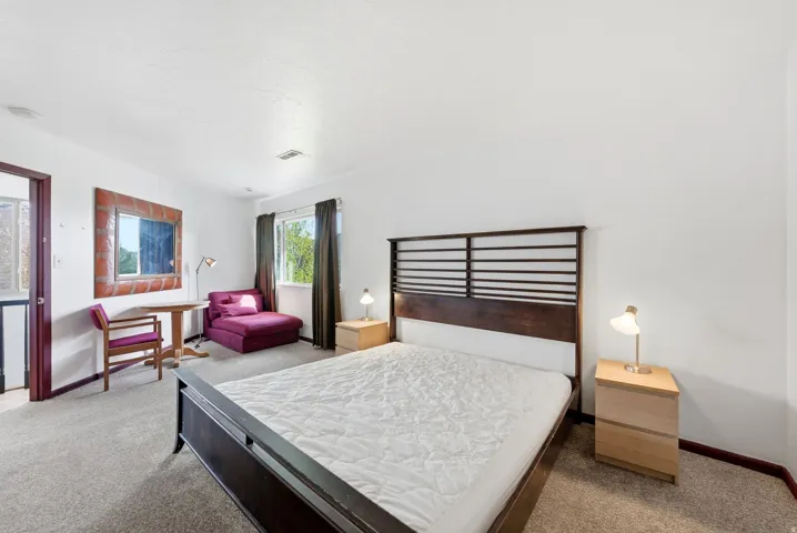 Spacious room featuring neutral carpeting and white walls