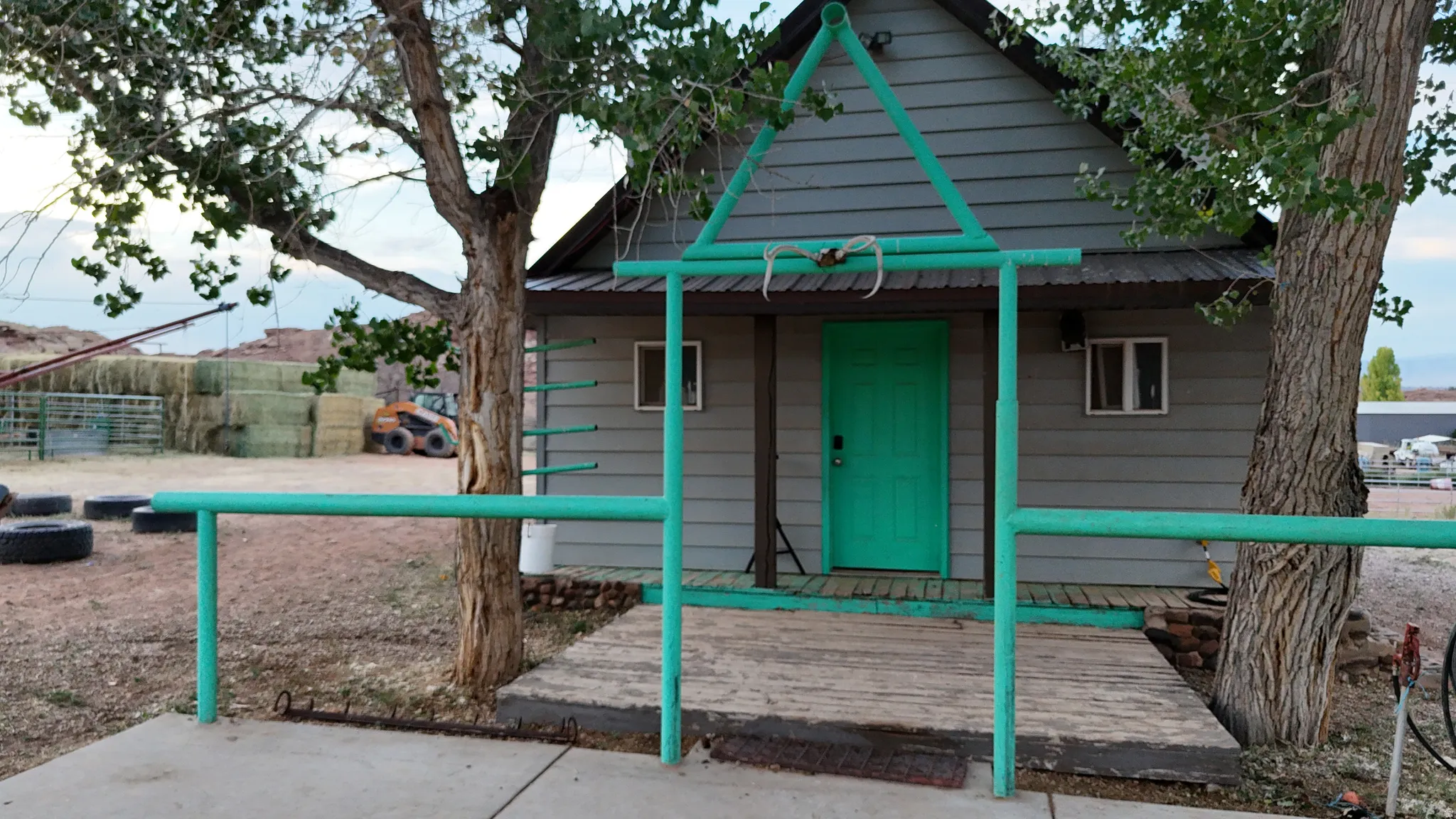 Structure with gray horizontal siding and a dark roofline