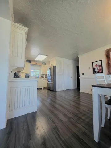 Wood-finish flooring extending throughout the kitchen and dining areas