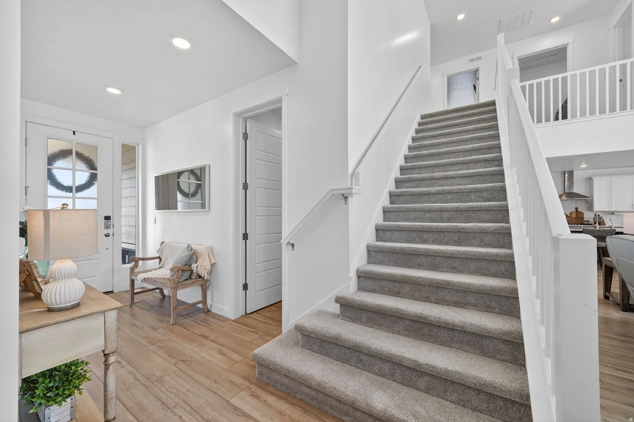 Grand staircase with carpeted treads and white railings