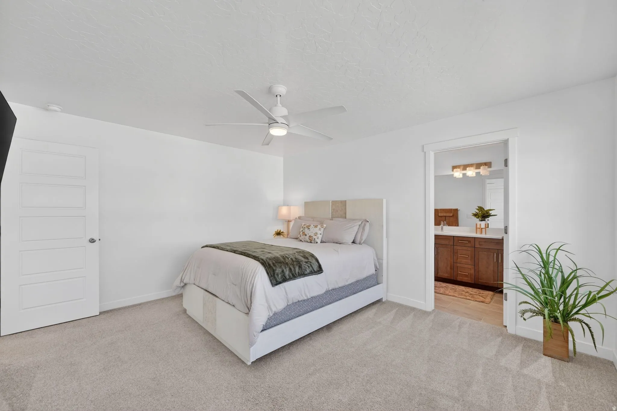 Spacious room featuring light-colored carpeting and a contemporary ceiling fan with integrated lighting
