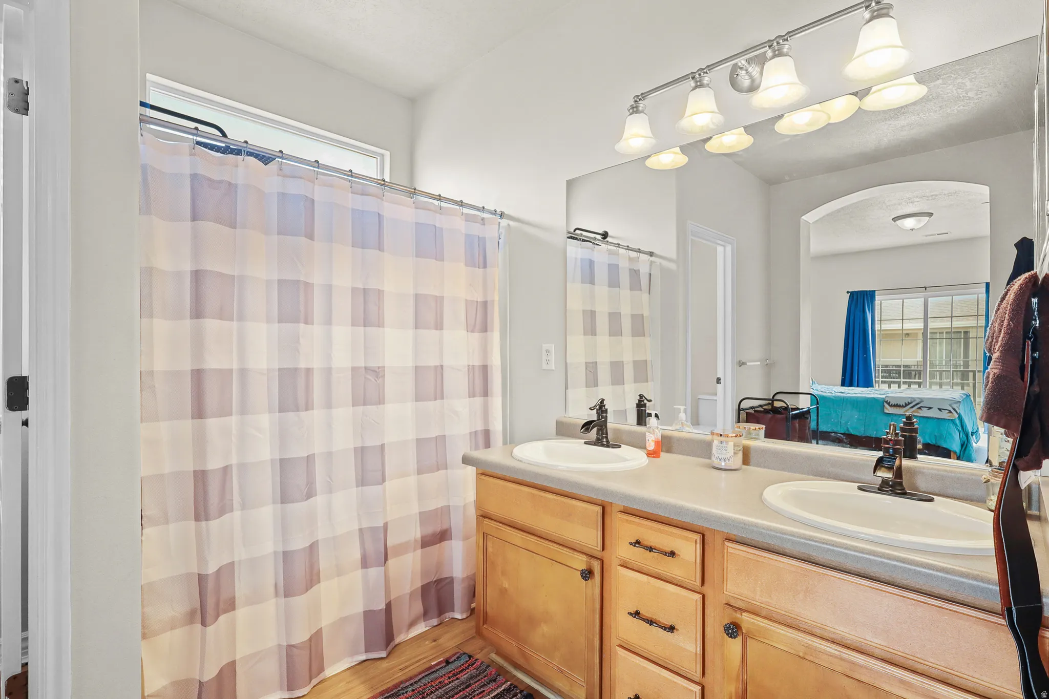 Double vanity with integrated sinks and dark bronze-finish faucets