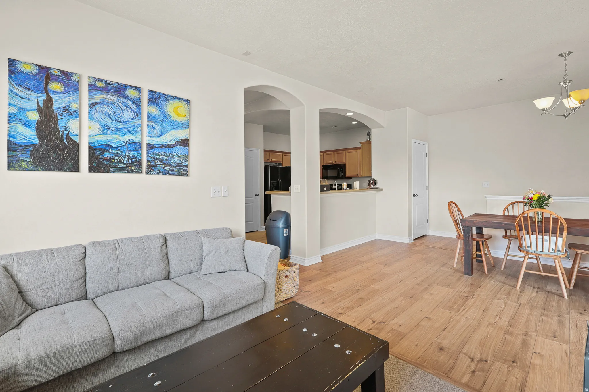 Open-concept living space featuring wood-finish flooring