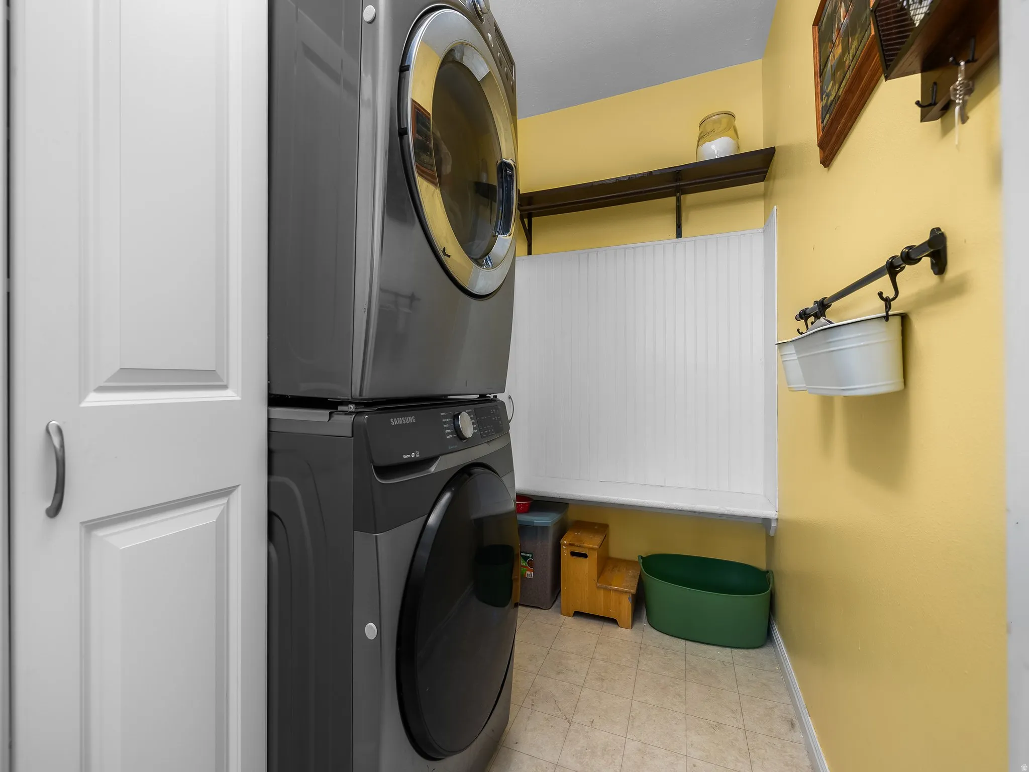 Dedicated laundry area featuring stacked appliances