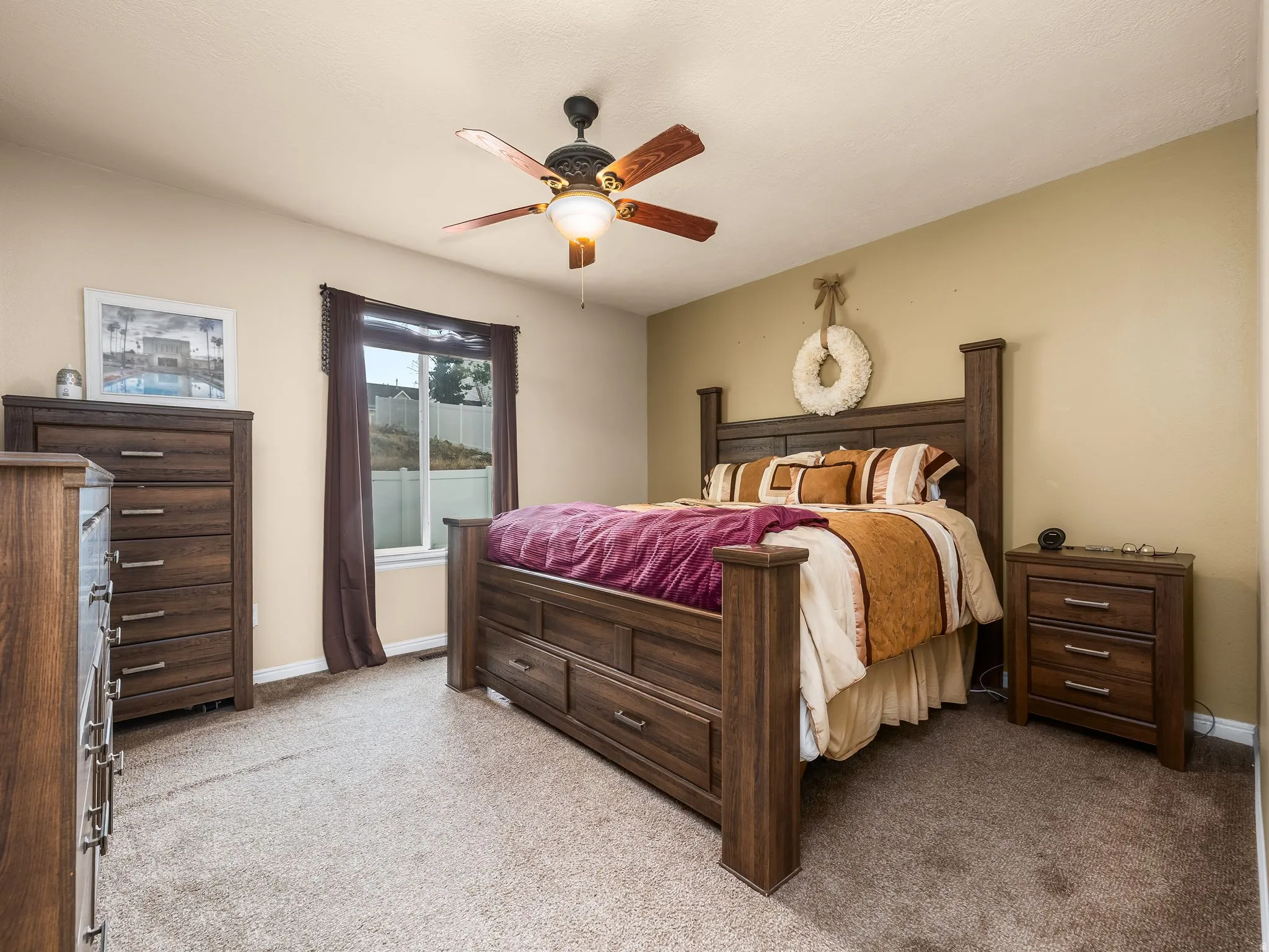 Primary Bedroom with neutral tone walls complement the textured carpeting