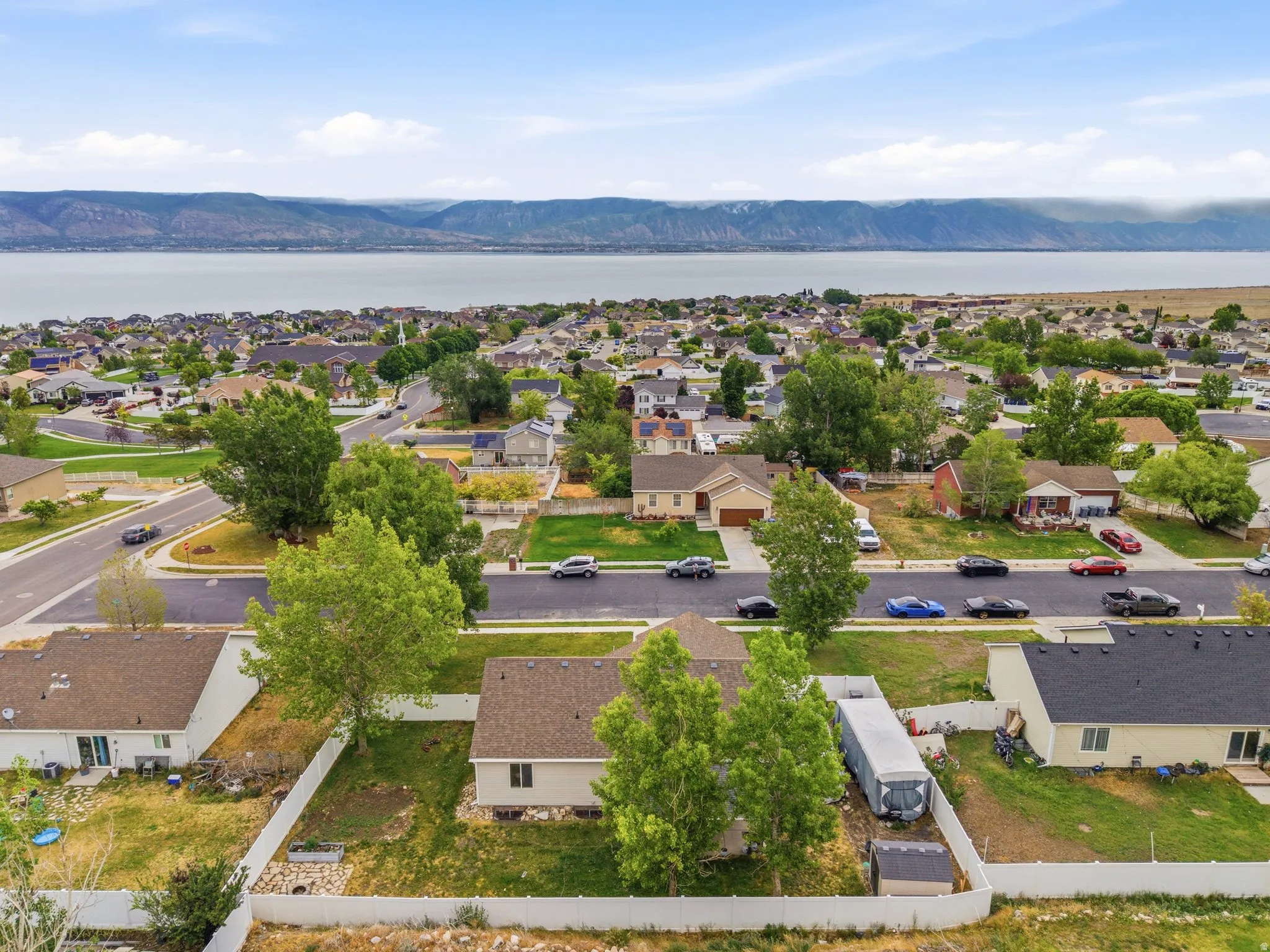 Expansive neighborhood with a large body of water and distant mountains