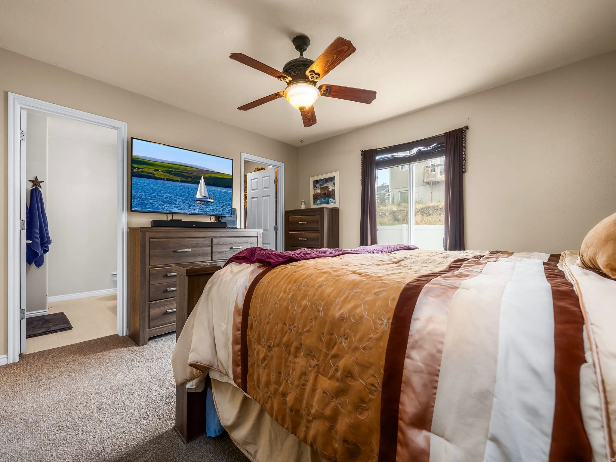 Neutral-toned walls complement the textured carpeting