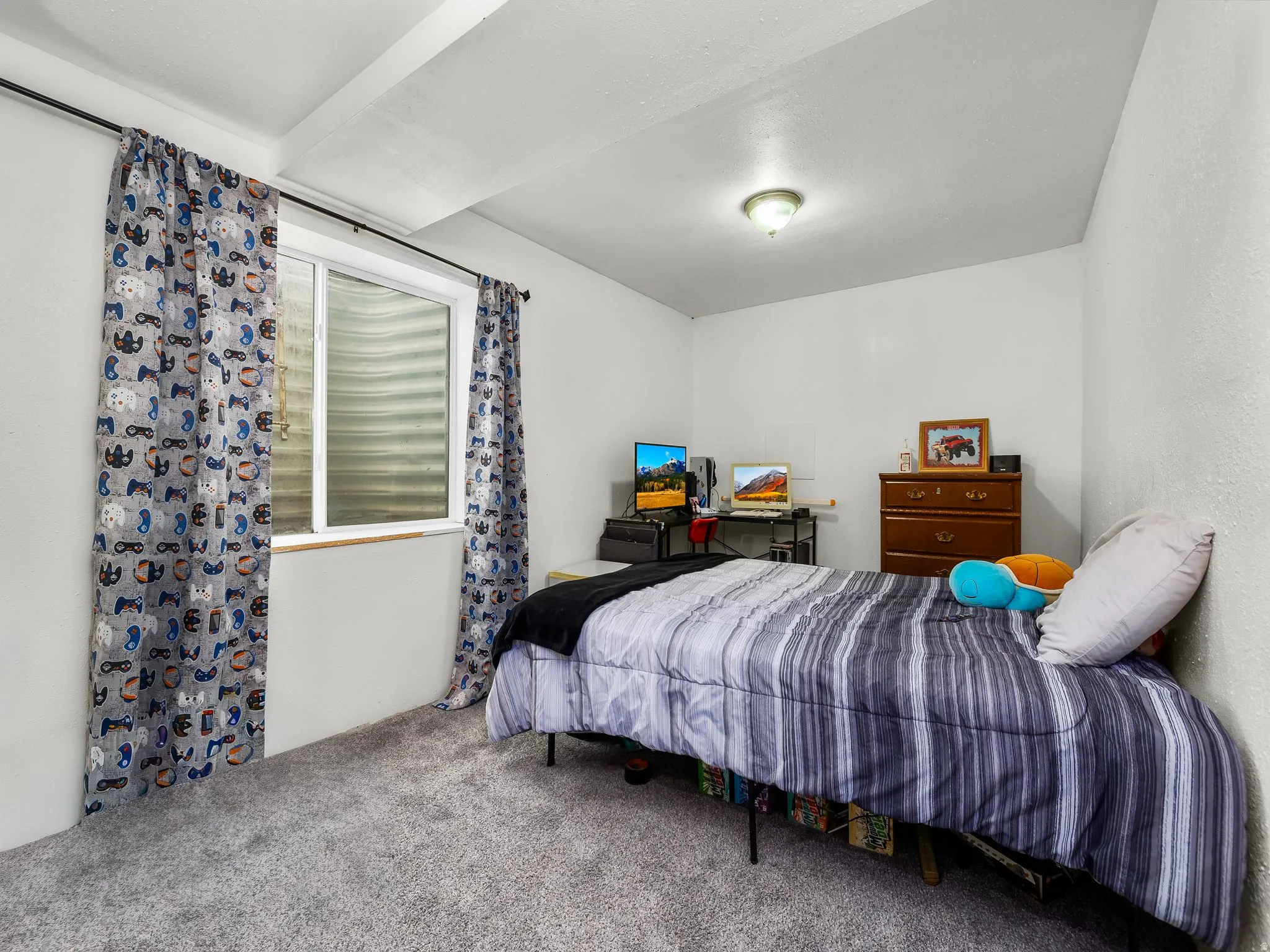 Bright bedroom featuring a recessed window with an egress well