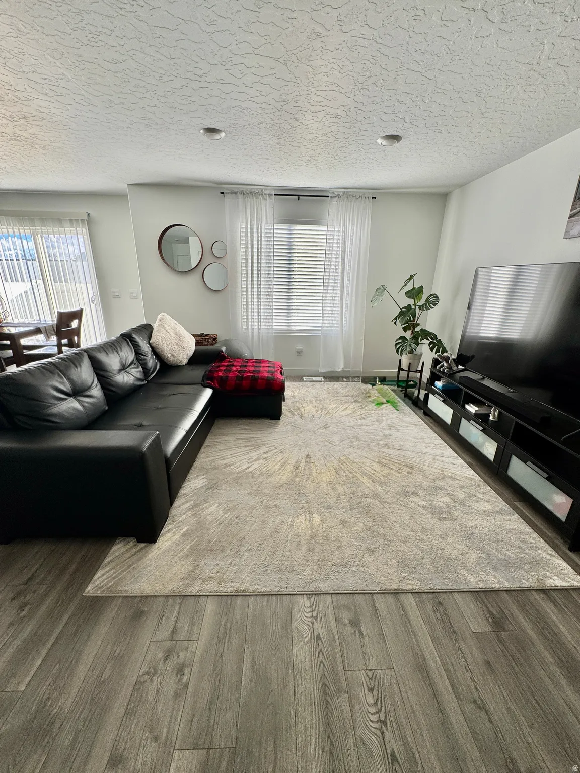 Open-concept living area featuring wood-finish flooring