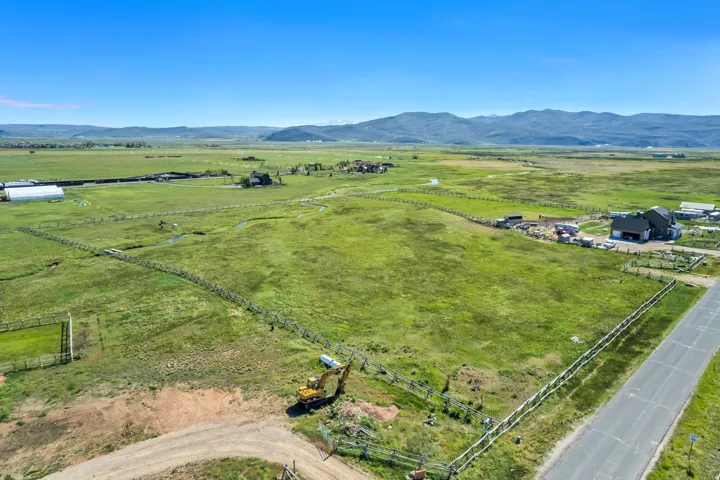 Expansive, fenced acreage with a partially paved road frontage