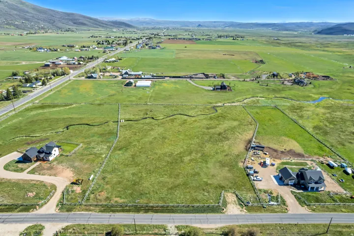 Expansive green acreage with distant mountain backdrop
