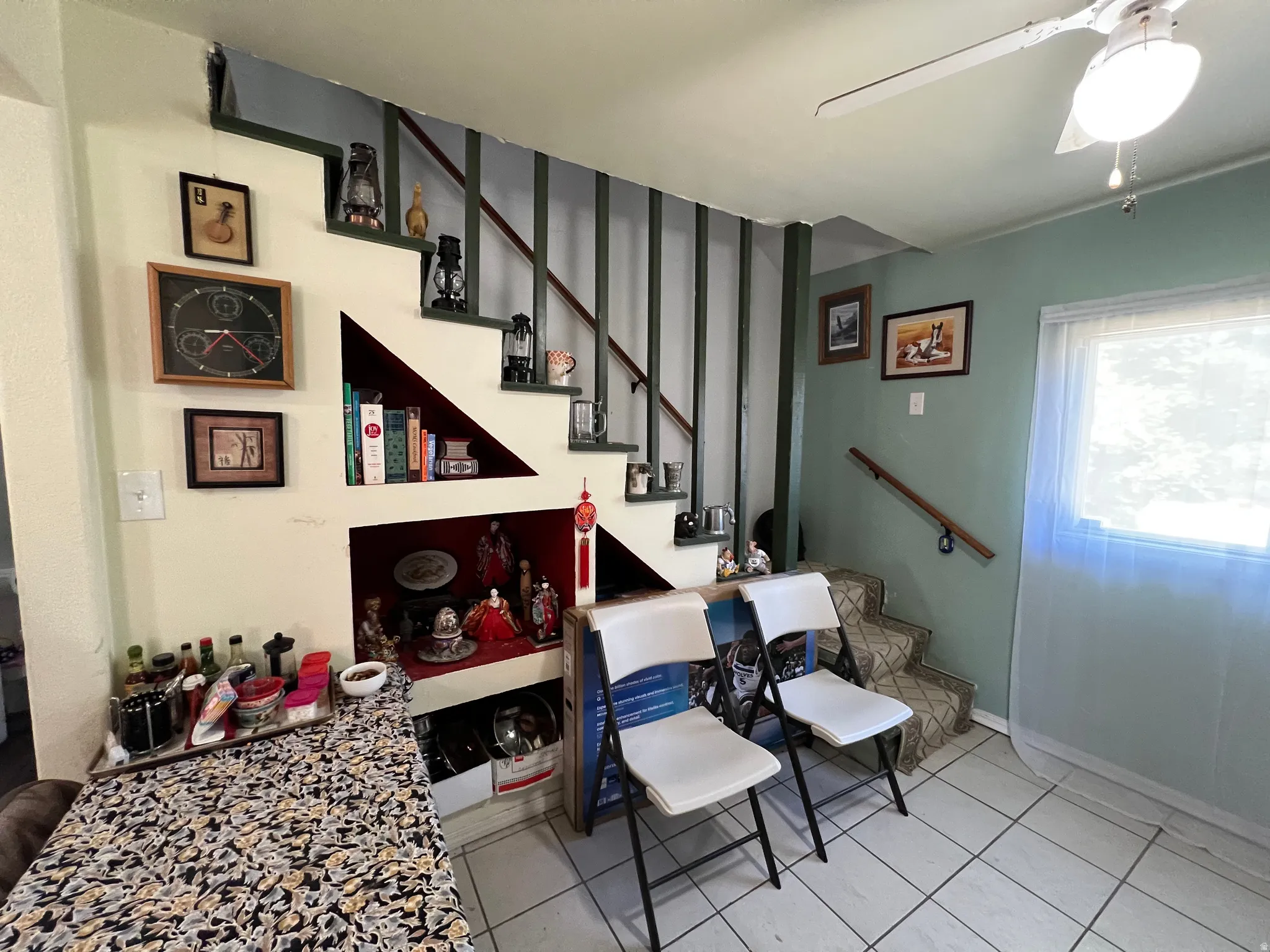 Staircase featuring dark green balusters and a built-in display nook