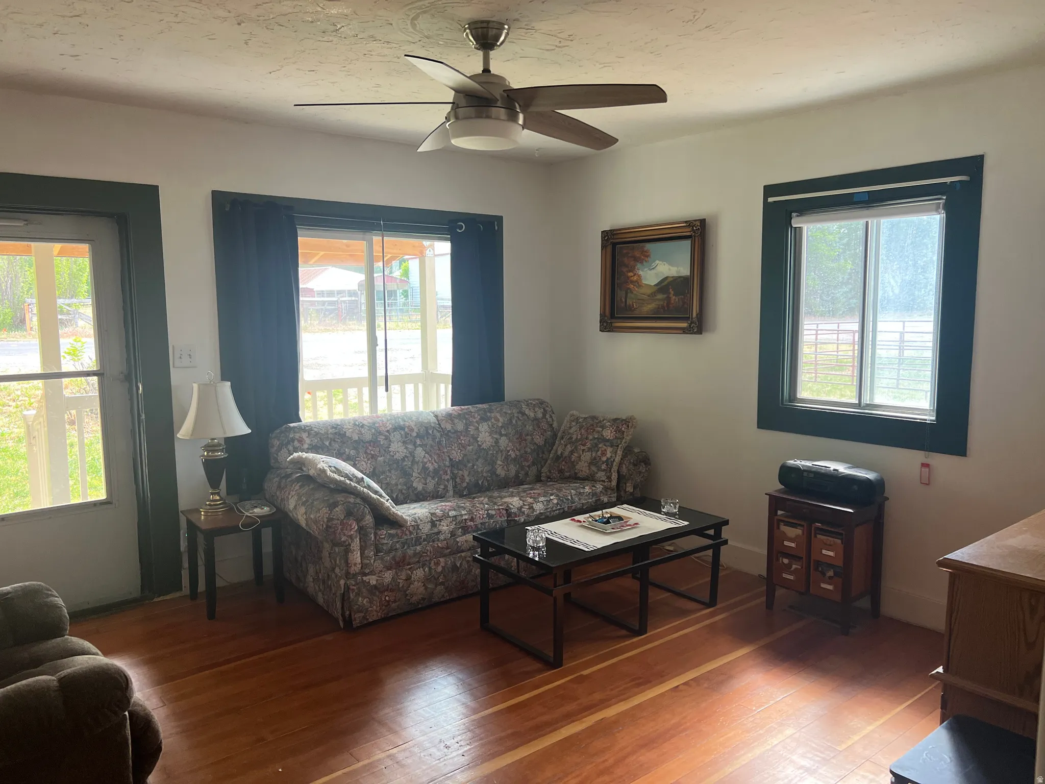 Room featuring wood-finish flooring, white walls, and dark trim