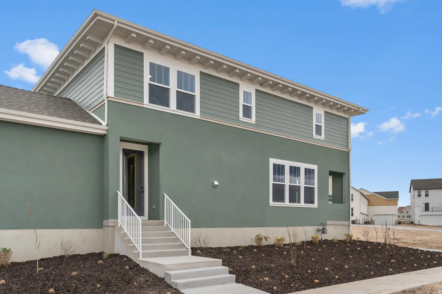 Contemporary exterior featuring green stucco and horizontal siding