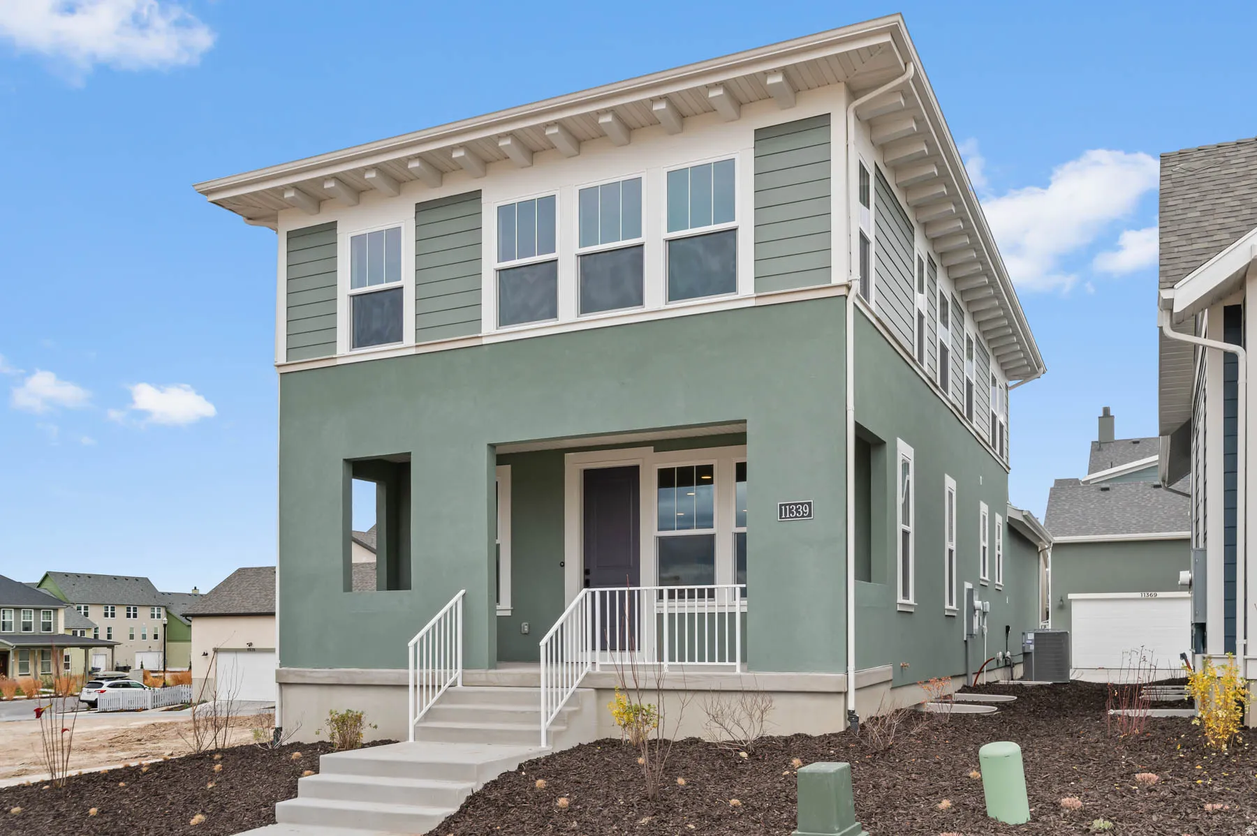 Contemporary two-story exterior featuring stucco and horizontal siding finishes