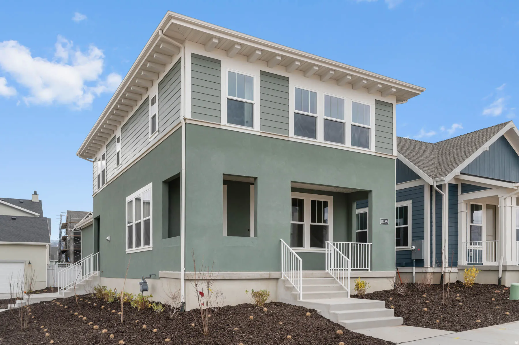 Contemporary exterior featuring a two-tone facade with a smooth stucco base and horizontal siding